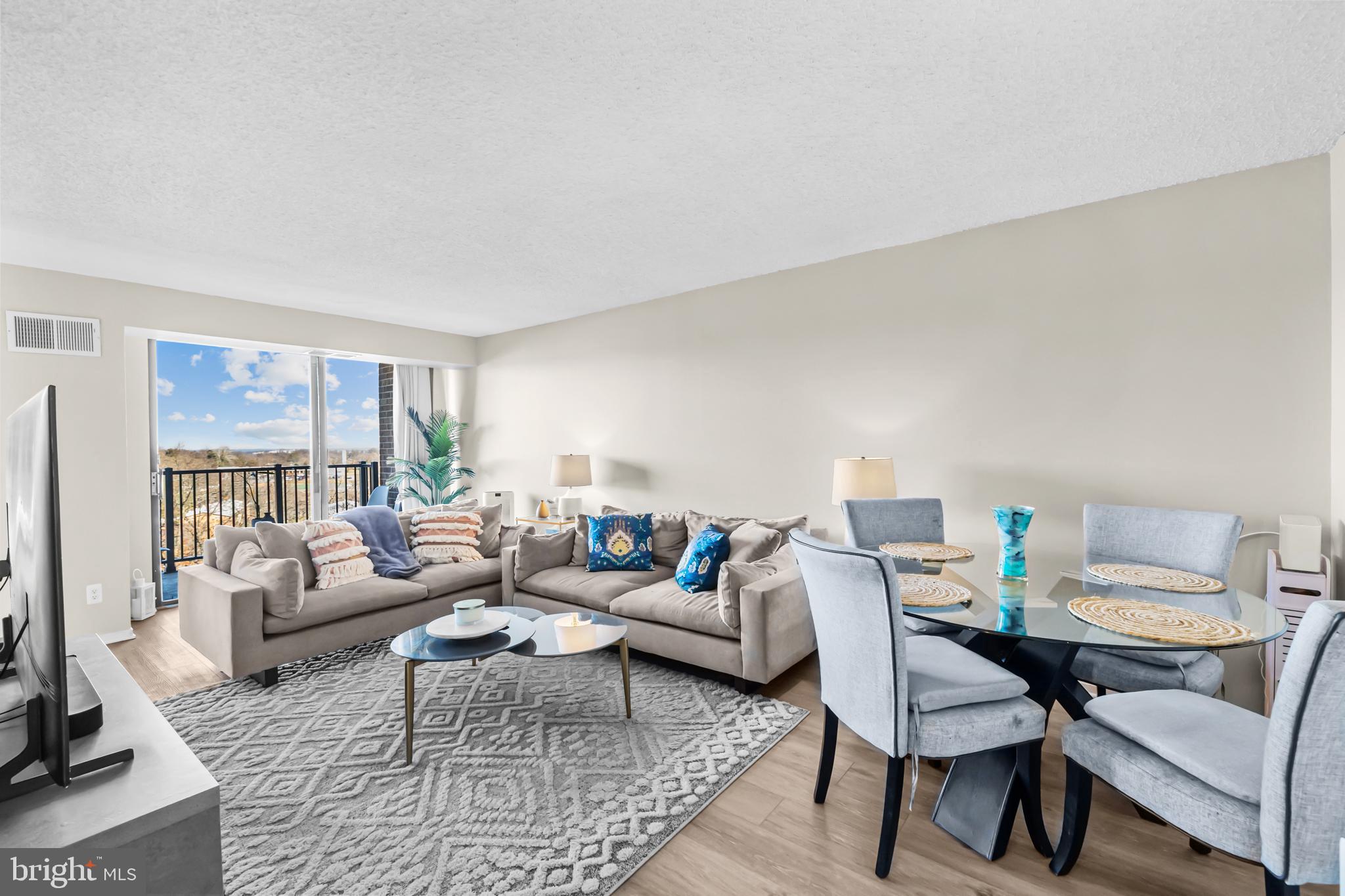 2300 Pimmit Drive, Unit 807 Falls Church, VA 22043 - Photo 7 of 33 a living room with furniture and a table