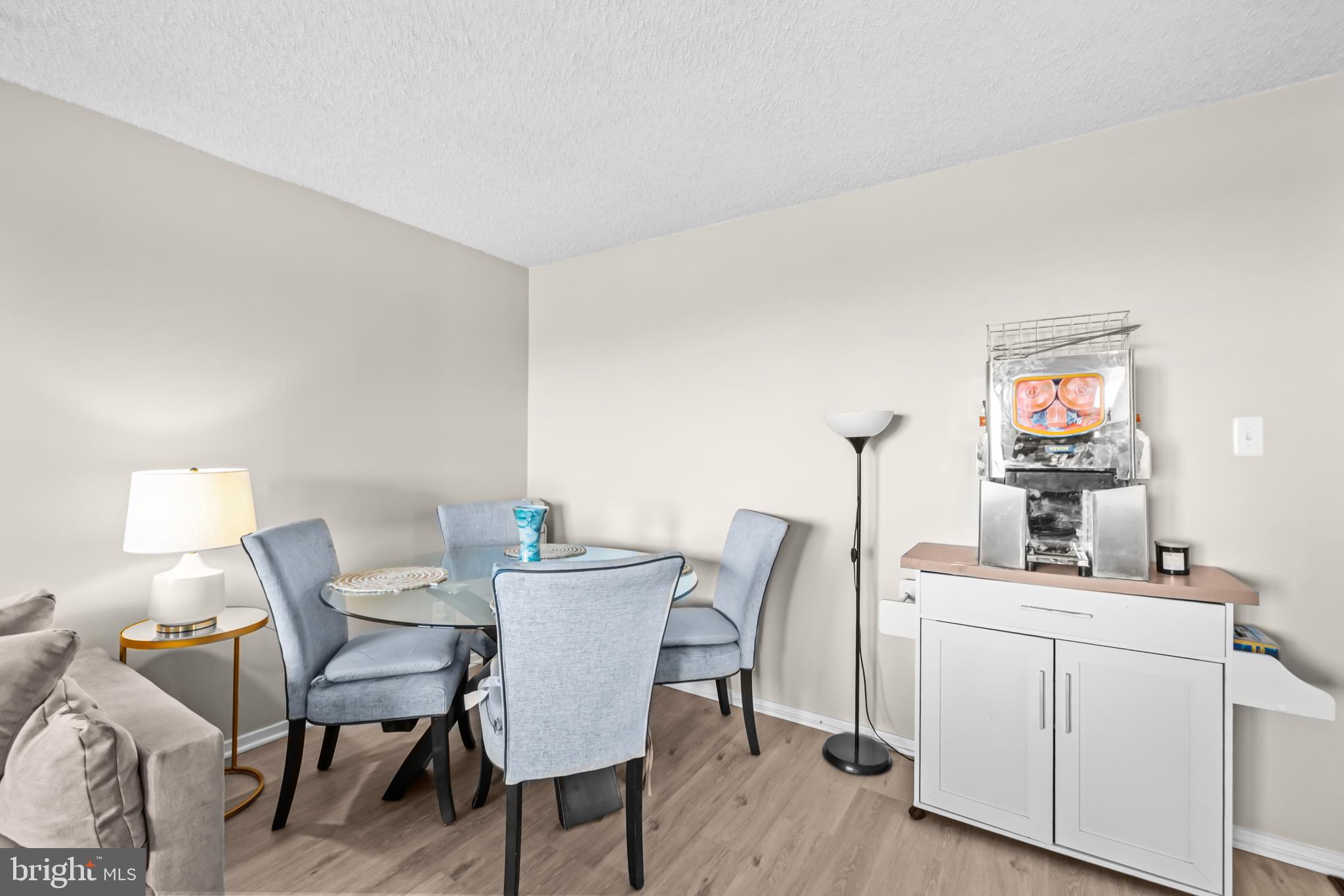 2300 Pimmit Drive, Unit 807 Falls Church, VA 22043 - Photo 8 of 33 a view of a dining room with furniture and wooden floor