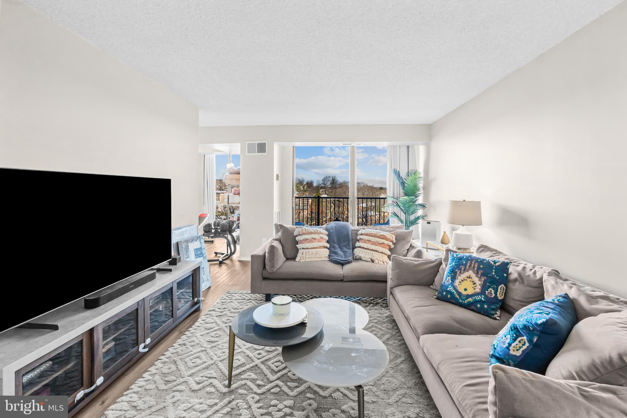2300 Pimmit Drive, Unit 807 Falls Church, VA 22043 - Photo 9 of 33 a living room with furniture and a flat screen tv