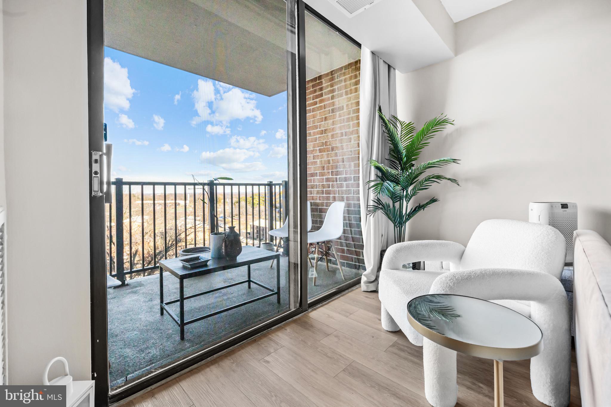 2300 Pimmit Drive, Unit 807 Falls Church, VA 22043 - Photo 10 of 33 a living room with furniture and a potted plant