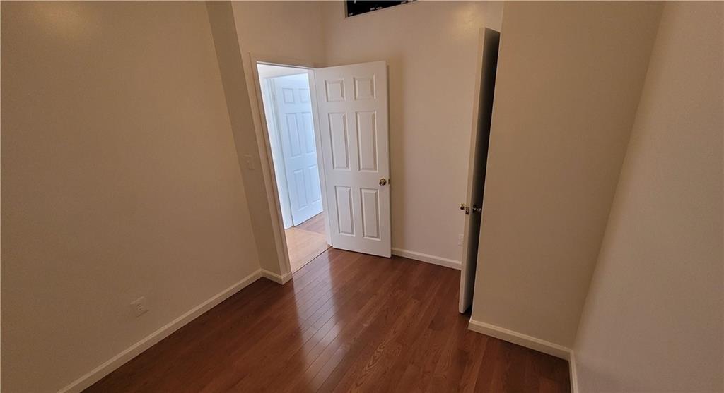 680 Hart Street Brooklyn, NY 11221 - Photo 4 of 8 an empty room with wooden floor