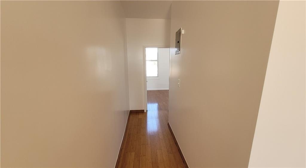 680 Hart Street Brooklyn, NY 11221 - Photo 5 of 8 a view of a hallway with wooden floor