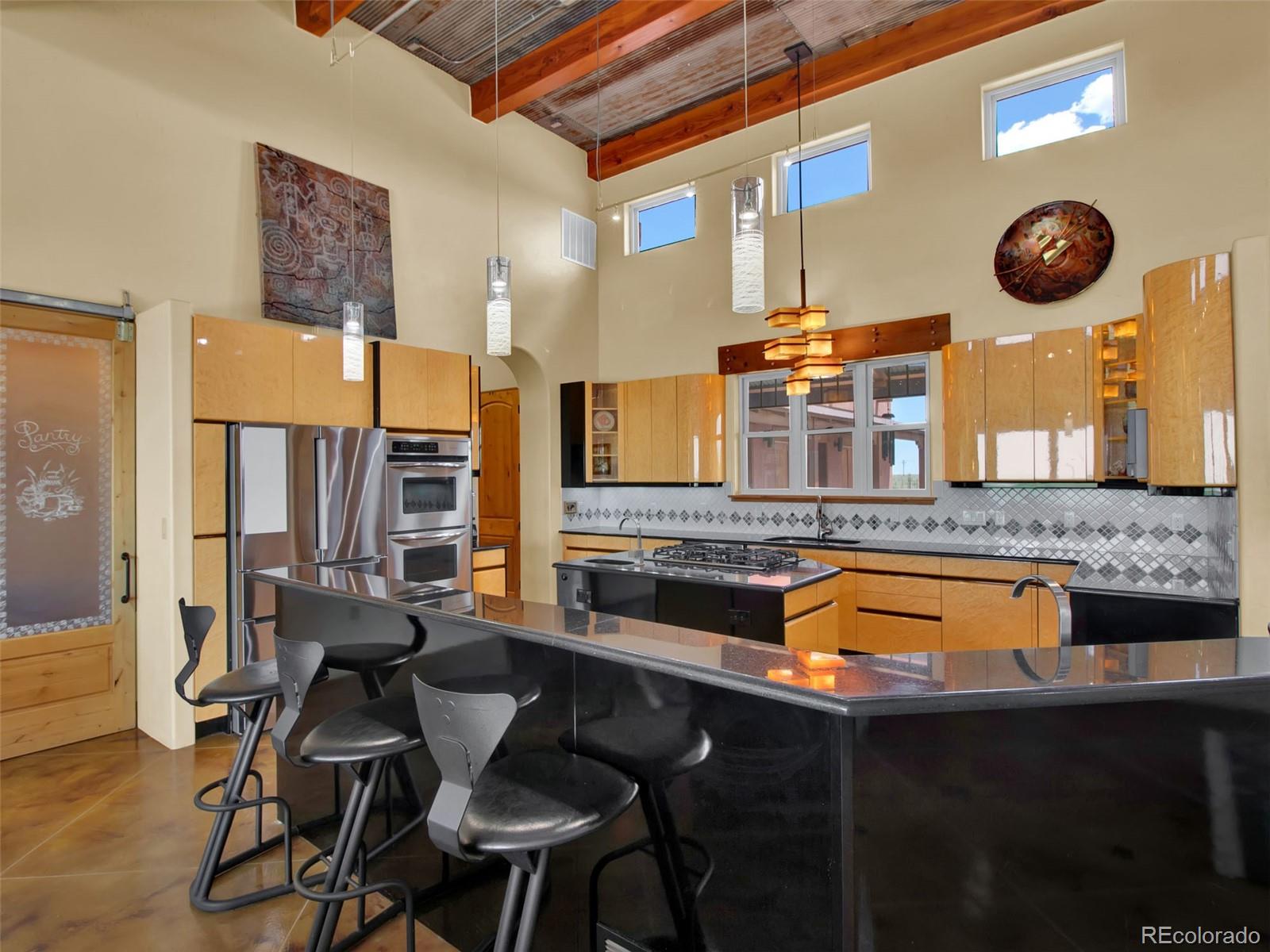 5549 Yulle Road Bennett, CO 80102 - Photo 22 of 47 a kitchen with a table chairs and a stove