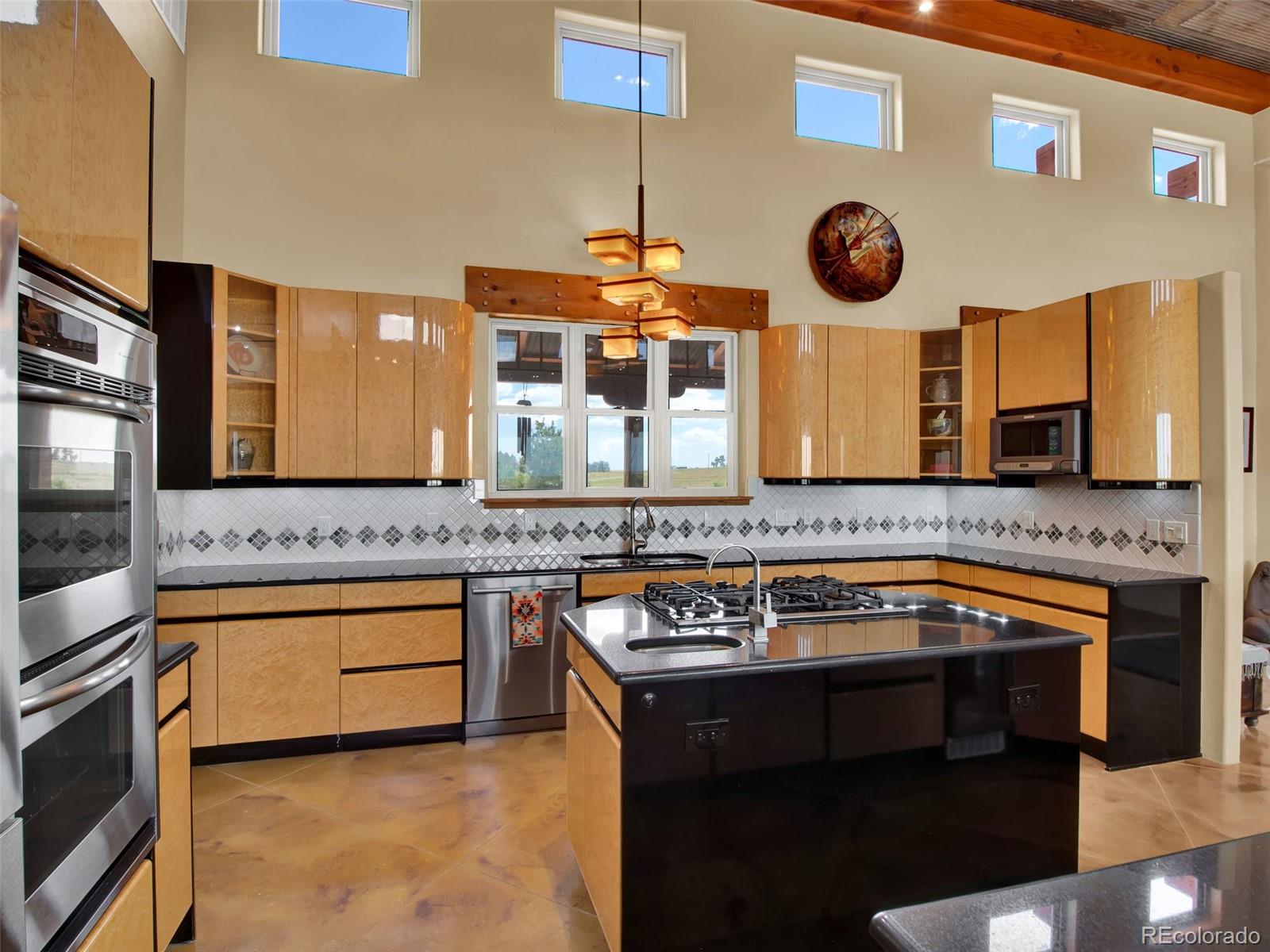 5549 Yulle Road Bennett, CO 80102 - Photo 23 of 47 a kitchen with a stove and a microwave