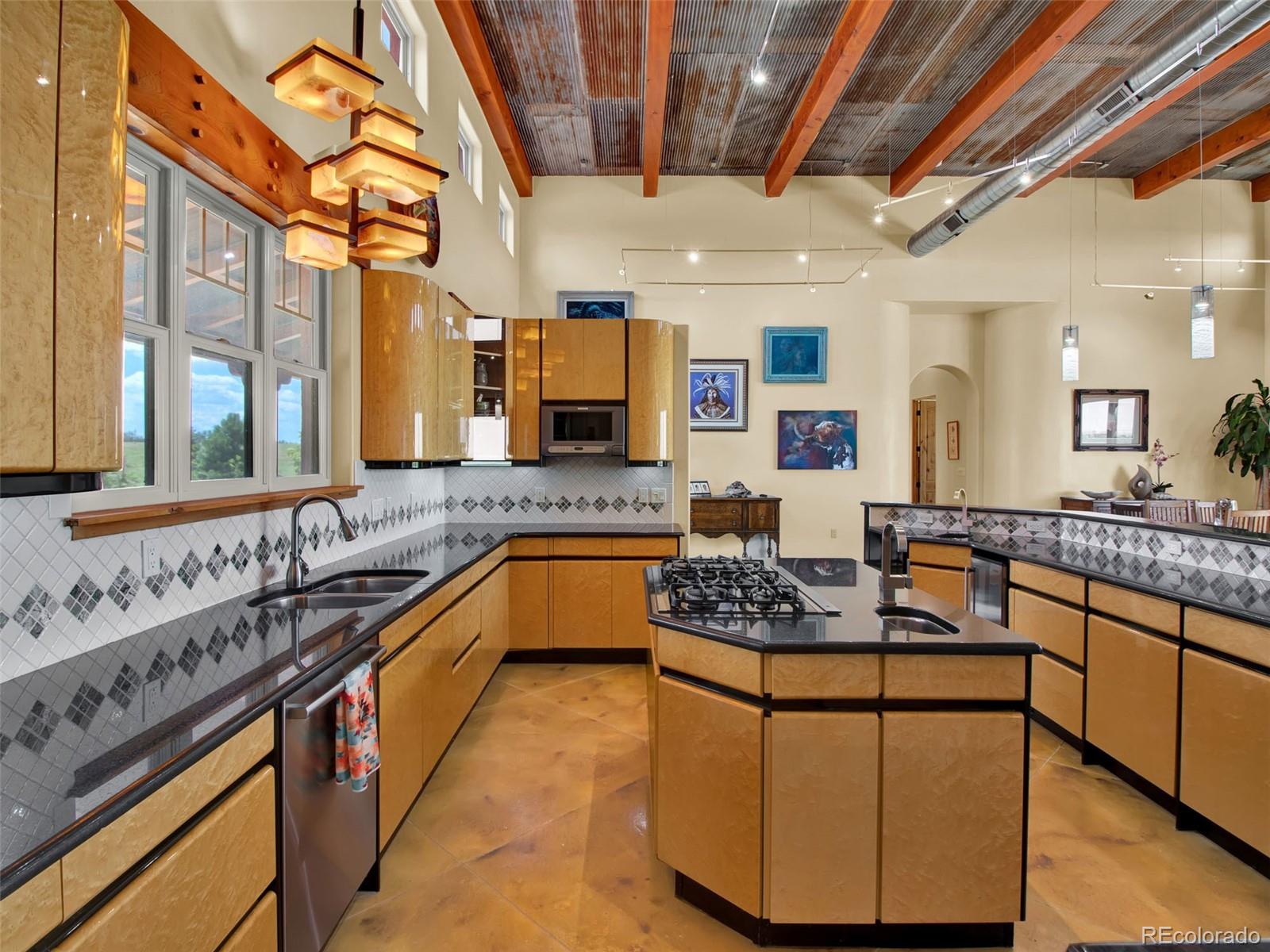 5549 Yulle Road Bennett, CO 80102 - Photo 24 of 47 a kitchen with stainless steel appliances granite countertop a sink stove and cabinets
