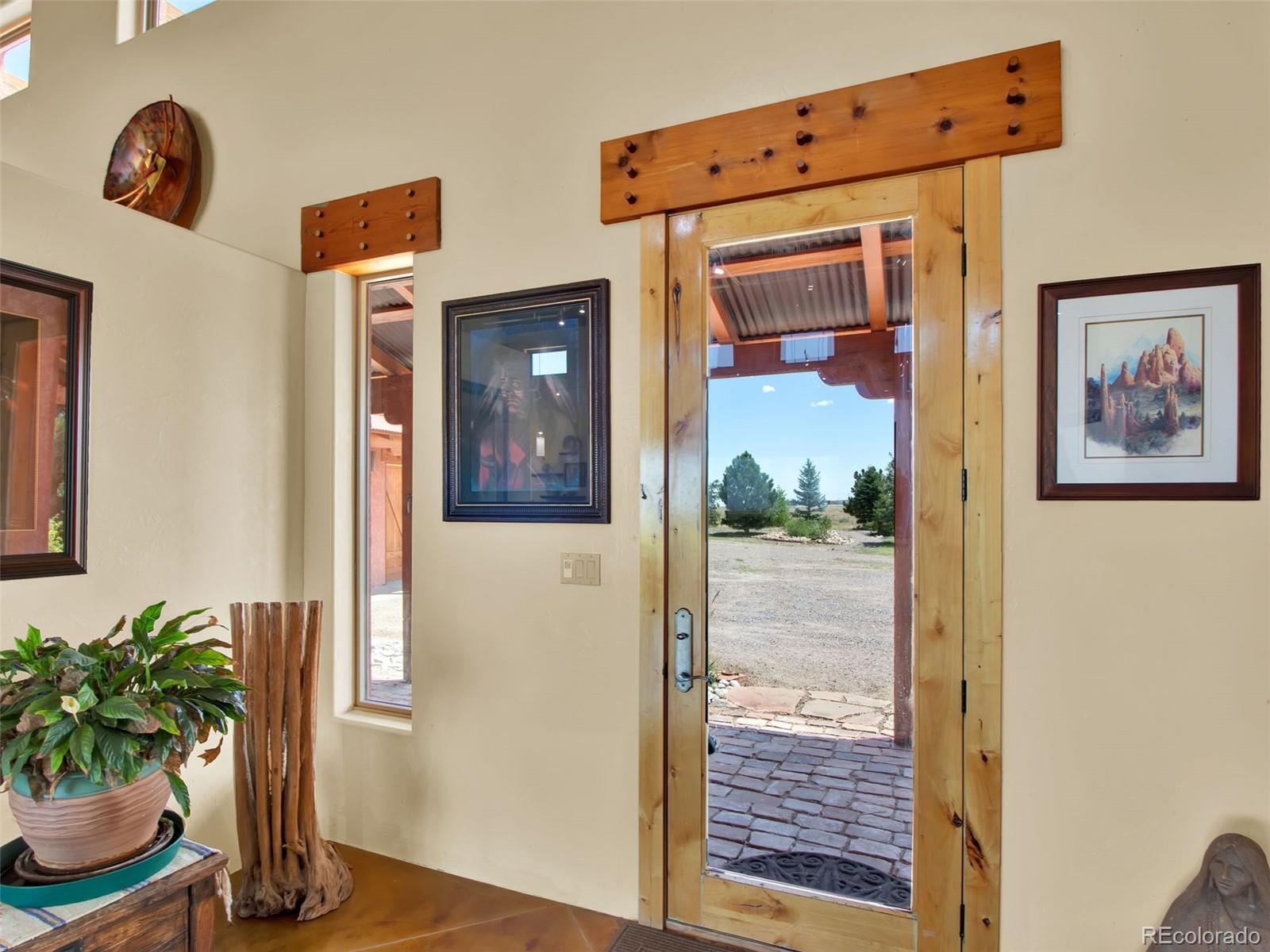 5549 Yulle Road Bennett, CO 80102 - Photo 26 of 47 a view of a hallway with wooden floor and a potted plant