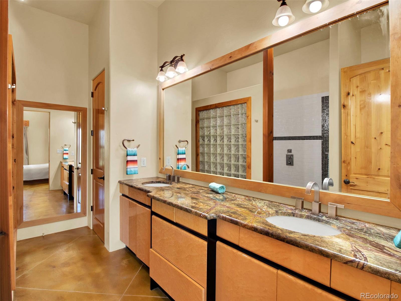 5549 Yulle Road Bennett, CO 80102 - Photo 31 of 47 a bathroom with a granite countertop sink and a mirror