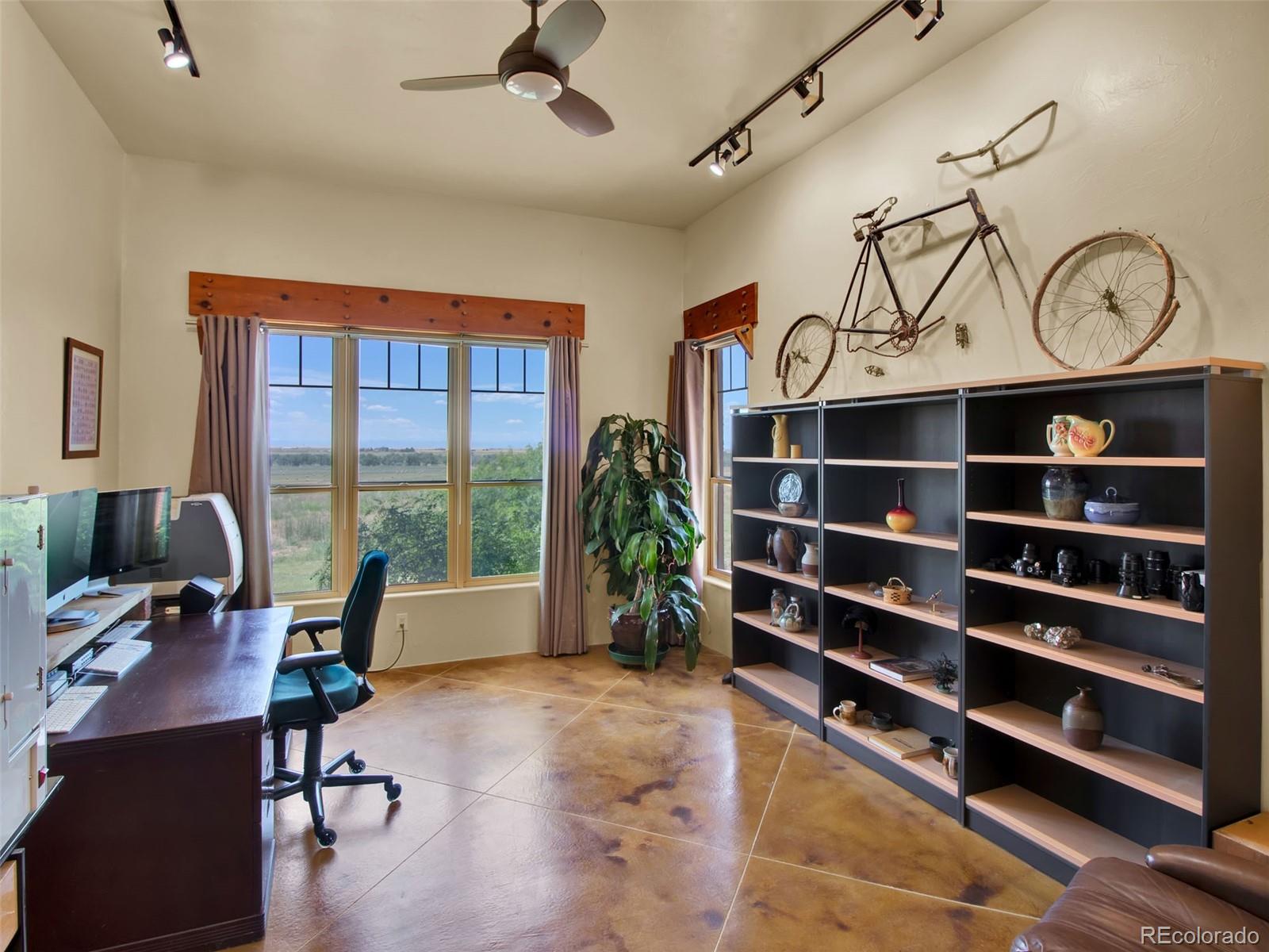 5549 Yulle Road Bennett, CO 80102 - Photo 34 of 47 a view of a workspace with furniture and a window