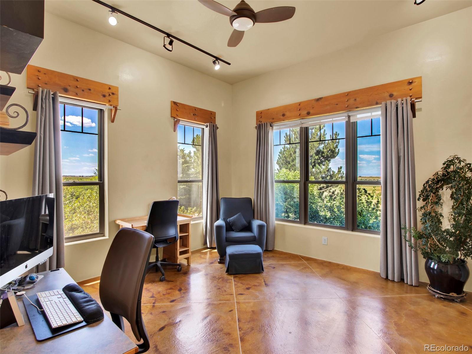 5549 Yulle Road Bennett, CO 80102 - Photo 36 of 47 a living room with furniture and floor to ceiling windows