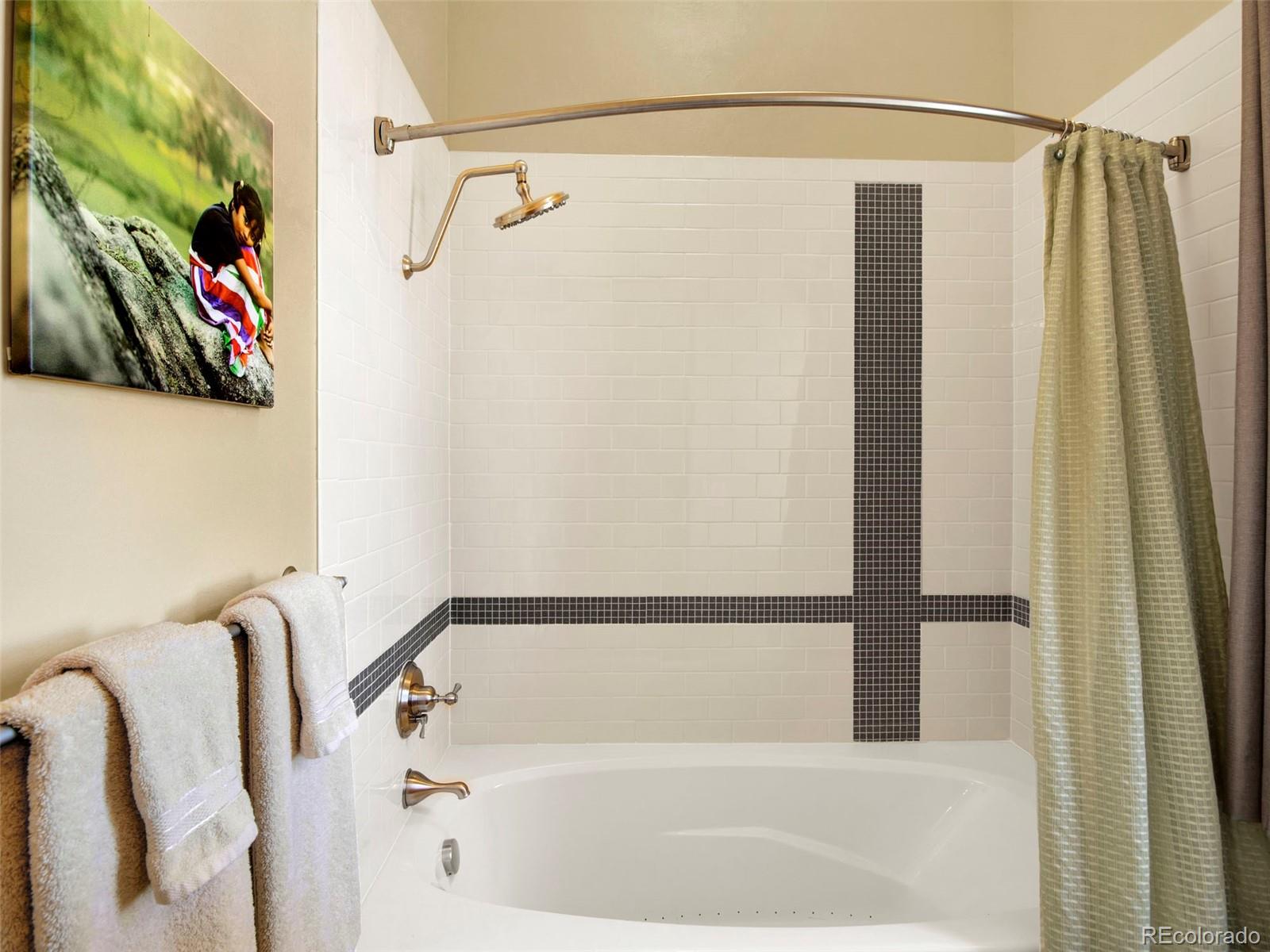 5549 Yulle Road Bennett, CO 80102 - Photo 38 of 47 a bathroom with a bathtub and a shower