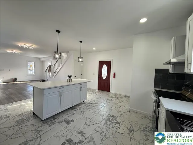 a view of living room with furniture and a flat screen tv