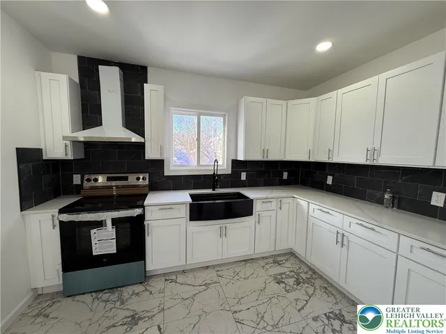 a kitchen with a stove a sink and a refrigerator