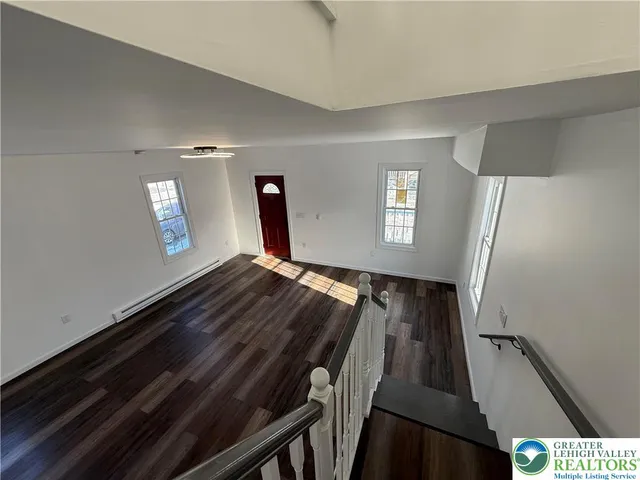 a view of wooden floor in a hall
