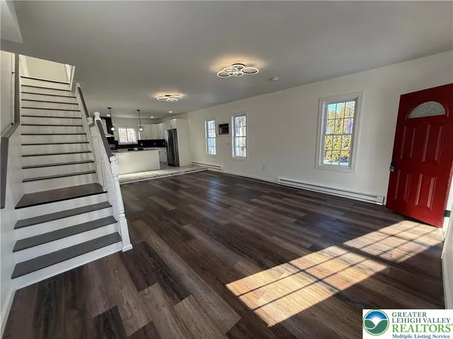 a view of entryway and hall with wooden floor