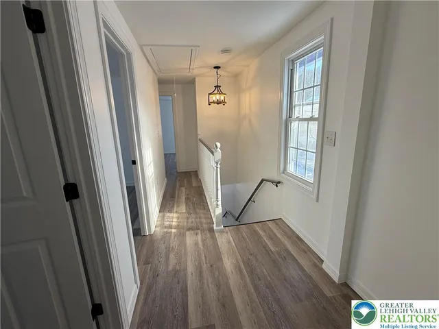 a view of entryway with wooden floor and stairs