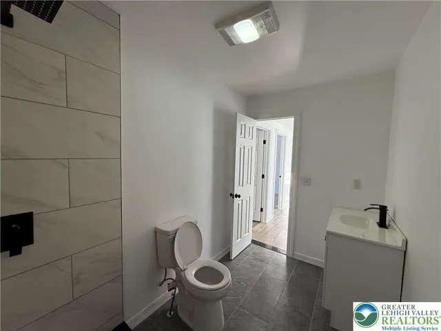 a bathroom with a toilet and a sink