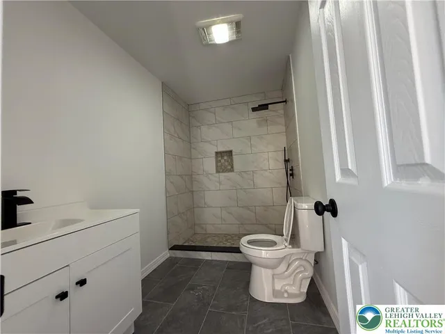 a bathroom with a toilet a sink and a mirror