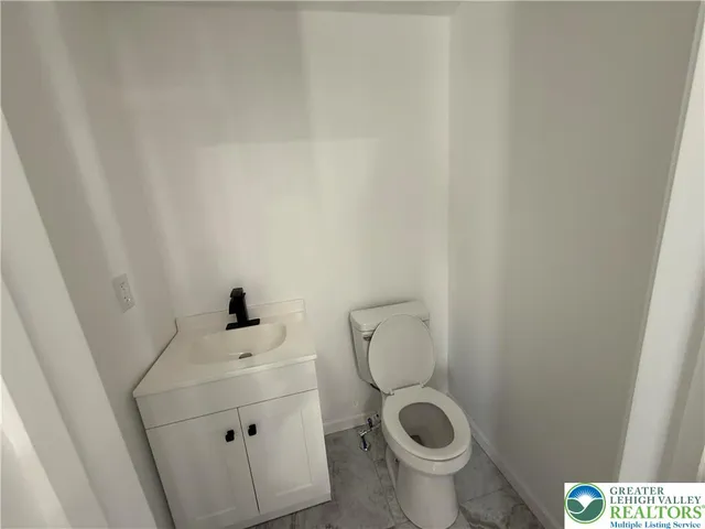 a bathroom with a toilet and a sink