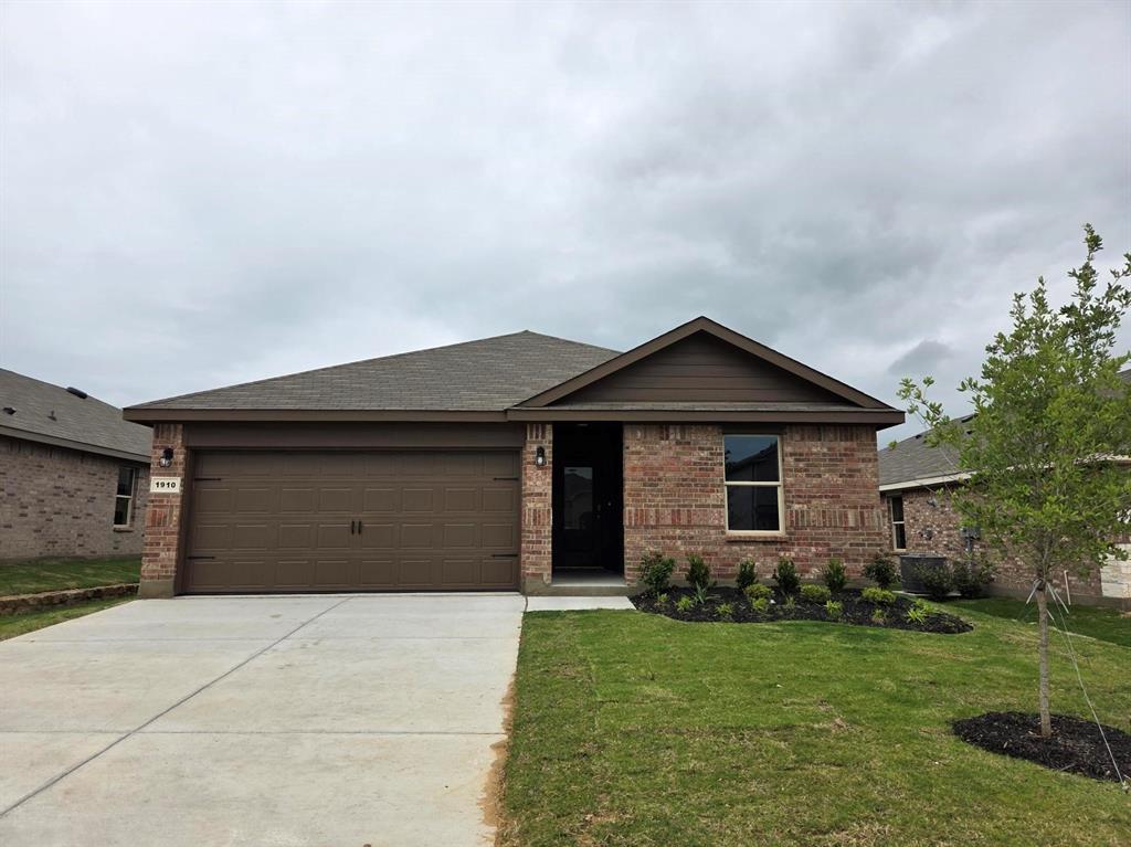 1910 Cherokee Lane Cleburne, TX 76033 - Photo 5 of 6 a view of a house with a yard and garage