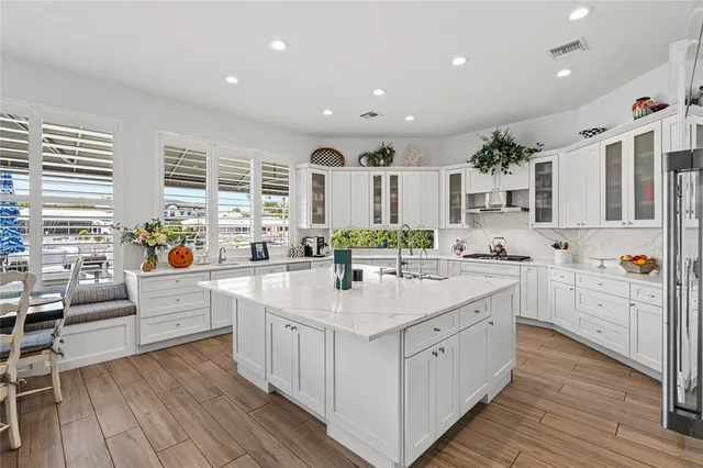 a large white kitchen with white cabinets and white appliances