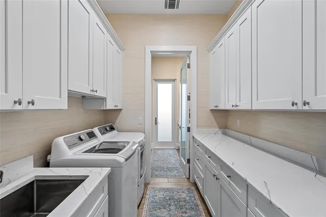 a kitchen with a sink stove and cabinets