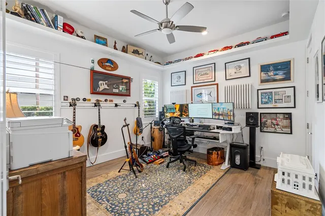 a view of a workspace with furniture and a window