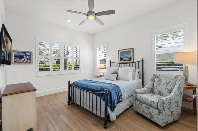 a bedroom with a bed couch and window