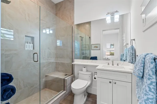 a bathroom with a sink toilet and shower