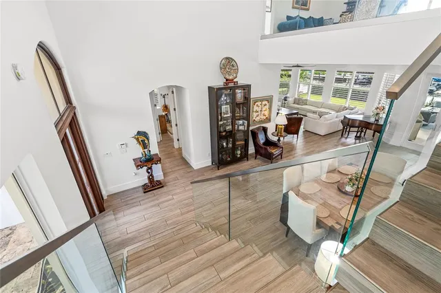 a view of a livingroom with furniture hardwood floor and staircase