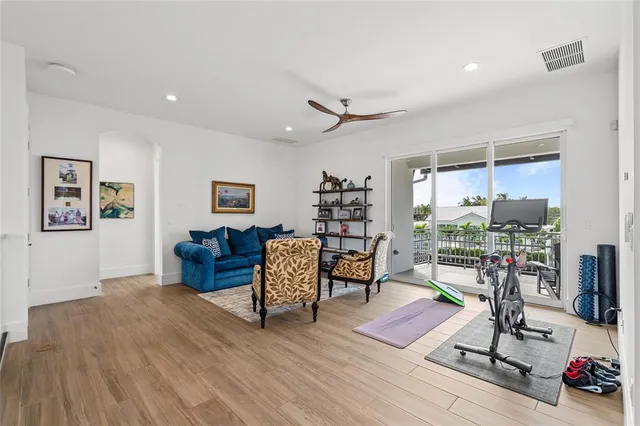a living room with furniture and a floor to ceiling window