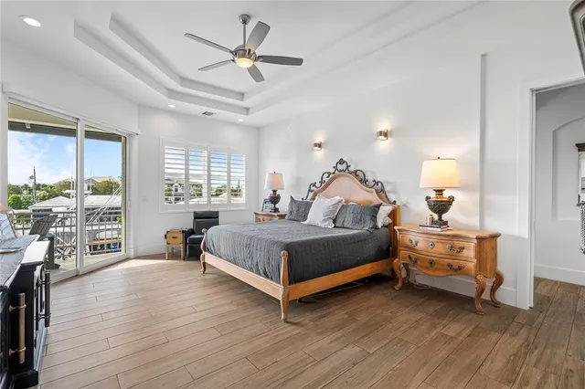 a living room with a bed furniture potted plant and a window