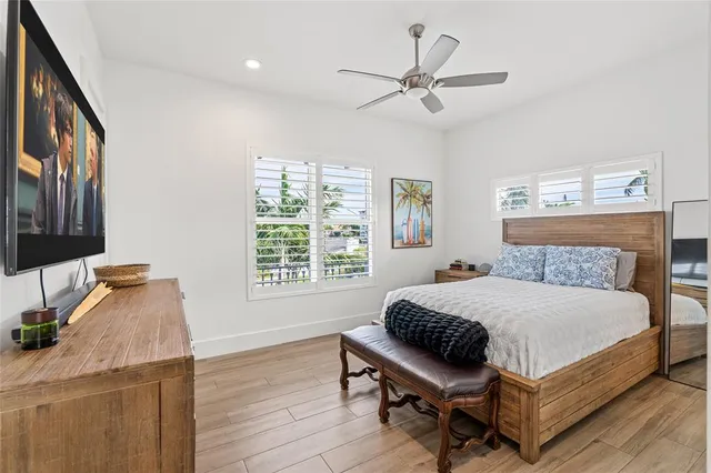 a bedroom with a bed window and a table