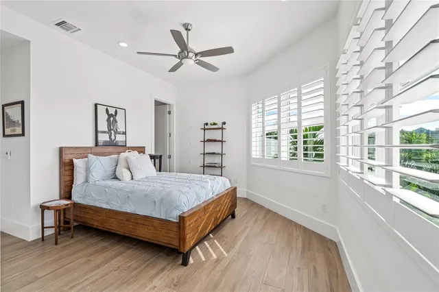 a bedroom with a bed and a large window