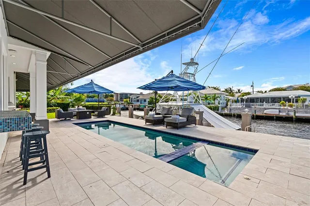 a view of a patio with dining table and chairs under an umbrella