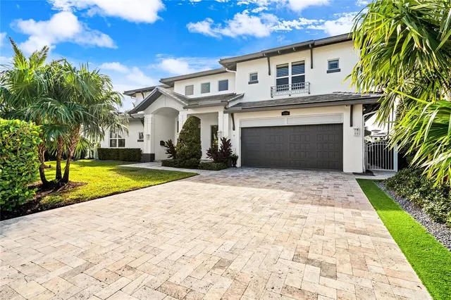 a view of a white house with a yard and plants