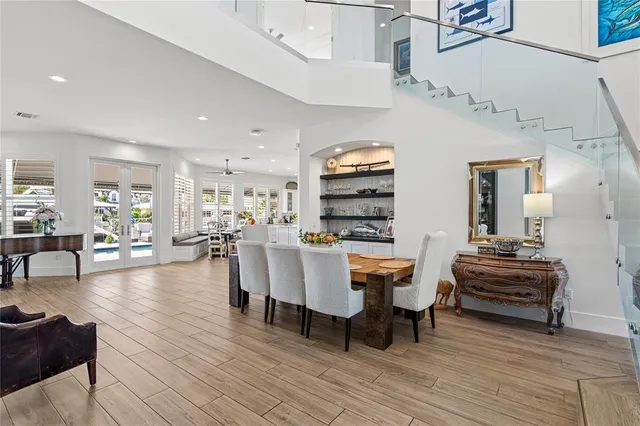 a living room with furniture a table and kitchen view