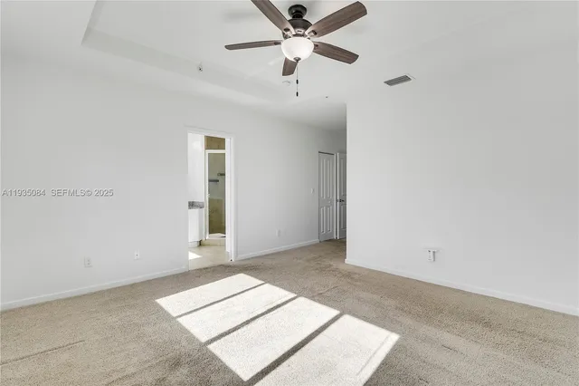 a view of a room with a ceiling fan and a window