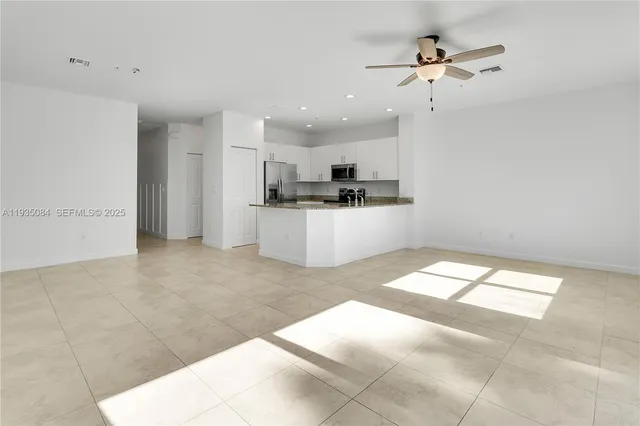 a view of a kitchen with a sink and microwave