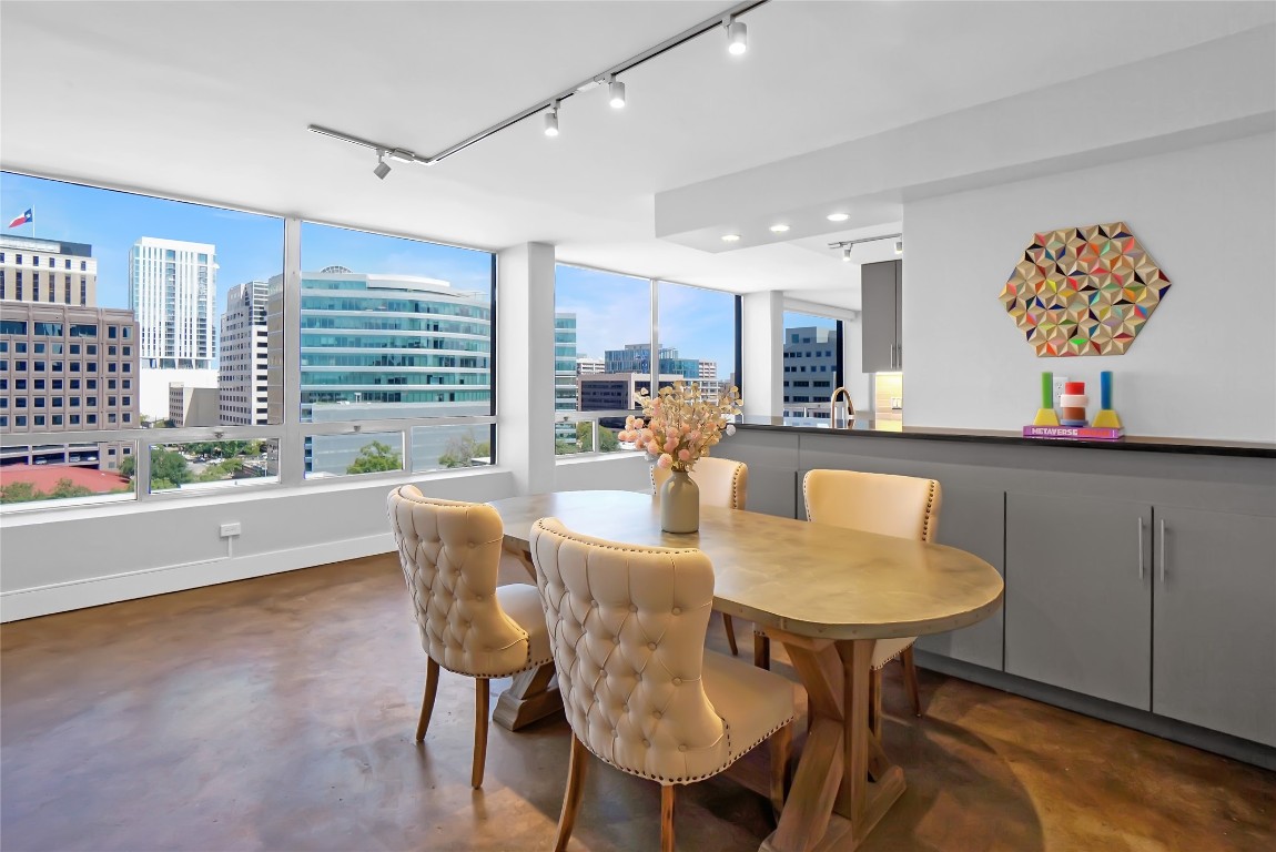 1212 Guadalupe Street, Unit 1004 Austin, TX 78701 - Photo 11 of 33 Dining area featuring a city view, concrete floors, and track lighting