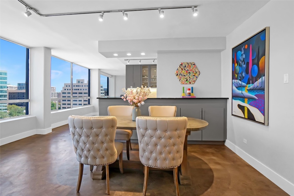 1212 Guadalupe Street, Unit 1004 Austin, TX 78701 - Photo 12 of 33 Dining area featuring finished concrete floors, a city view, and track lighting