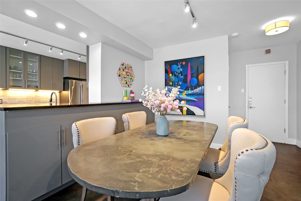 1212 Guadalupe Street, Unit 1004 Austin, TX 78701 - Photo 13 of 33 Dining area featuring rail lighting and baseboards