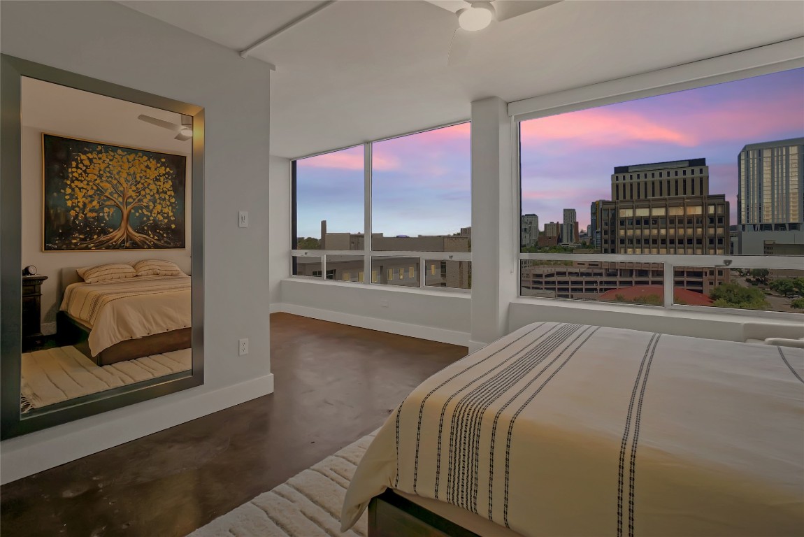 1212 Guadalupe Street, Unit 1004 Austin, TX 78701 - Photo 19 of 33 Bedroom featuring concrete floors, a view of city, and ceiling fan