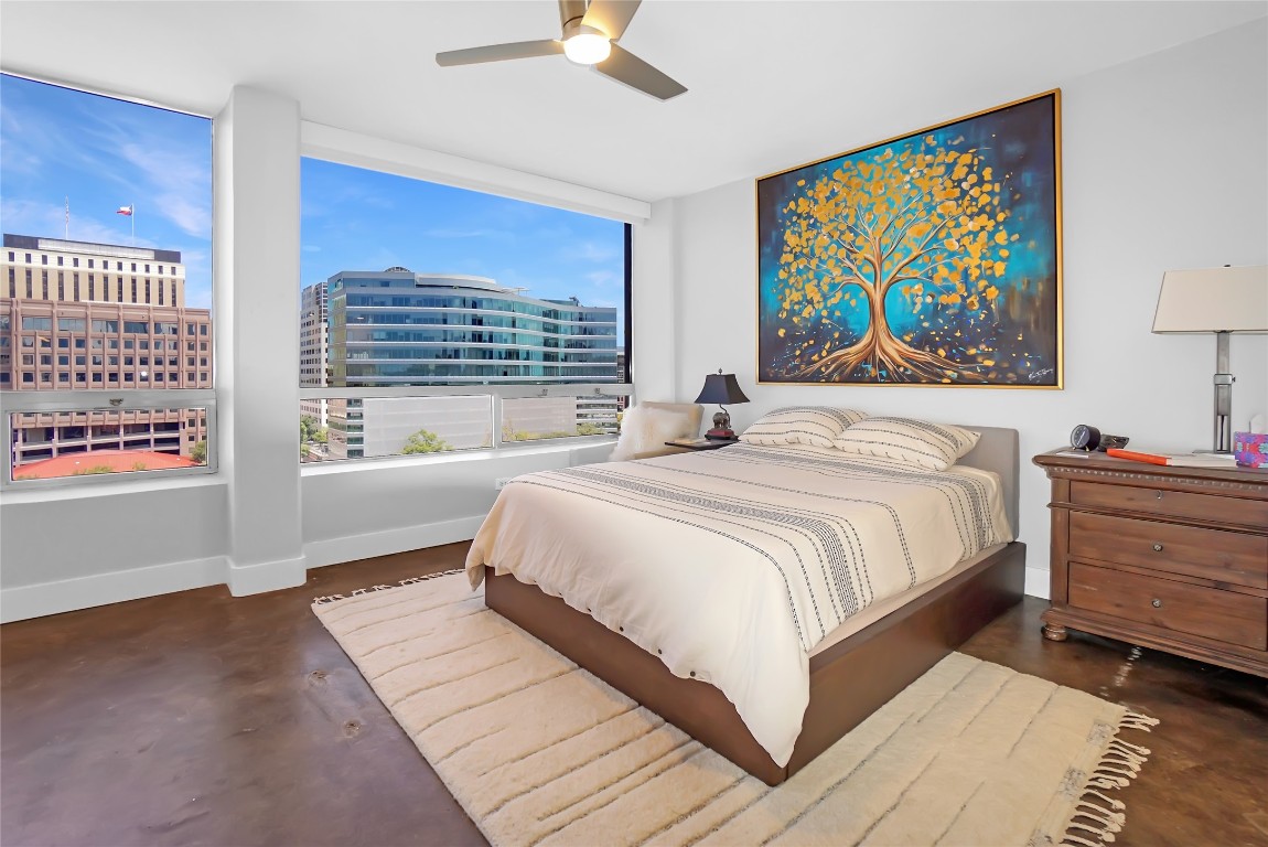 1212 Guadalupe Street, Unit 1004 Austin, TX 78701 - Photo 22 of 33 Bedroom with finished concrete floors, multiple windows, and a ceiling fan