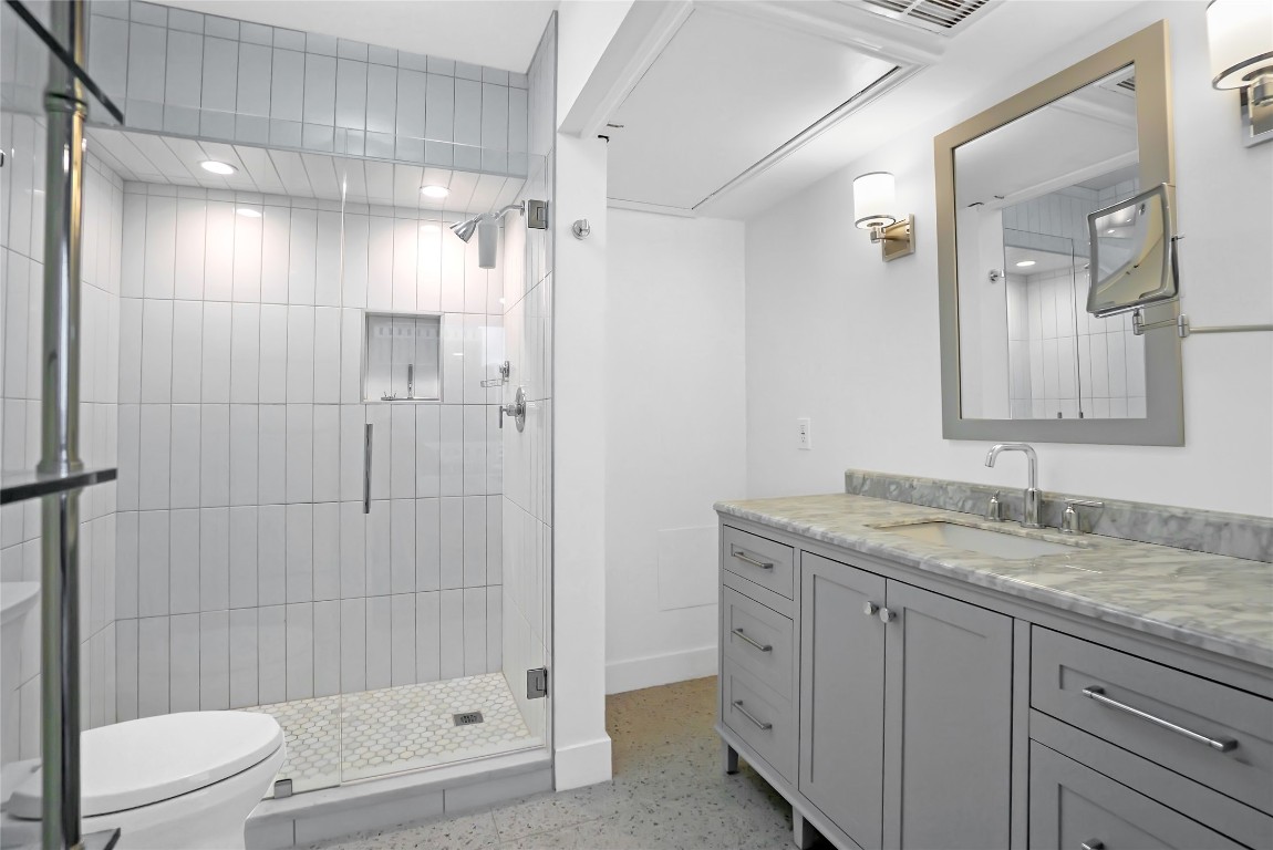 1212 Guadalupe Street, Unit 1004 Austin, TX 78701 - Photo 25 of 33 Bathroom featuring vanity, a stall shower, and dark speckled floor