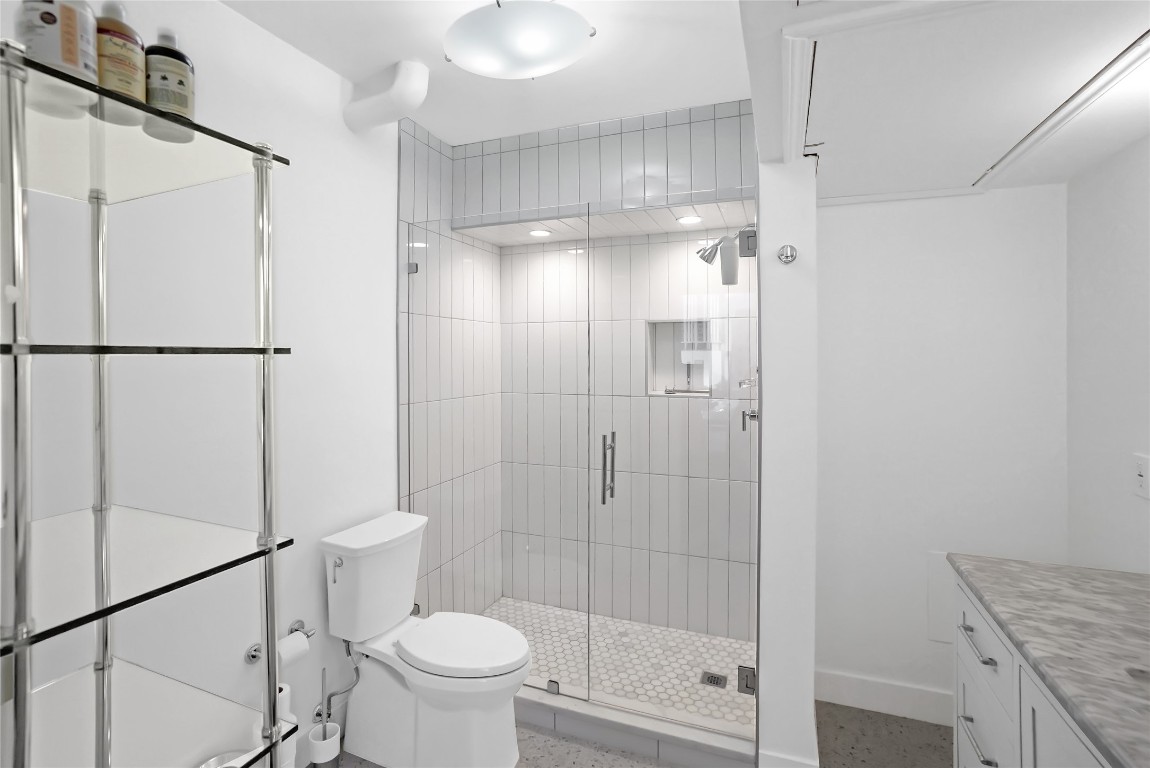 1212 Guadalupe Street, Unit 1004 Austin, TX 78701 - Photo 26 of 33 Bathroom with a shower stall and vanity