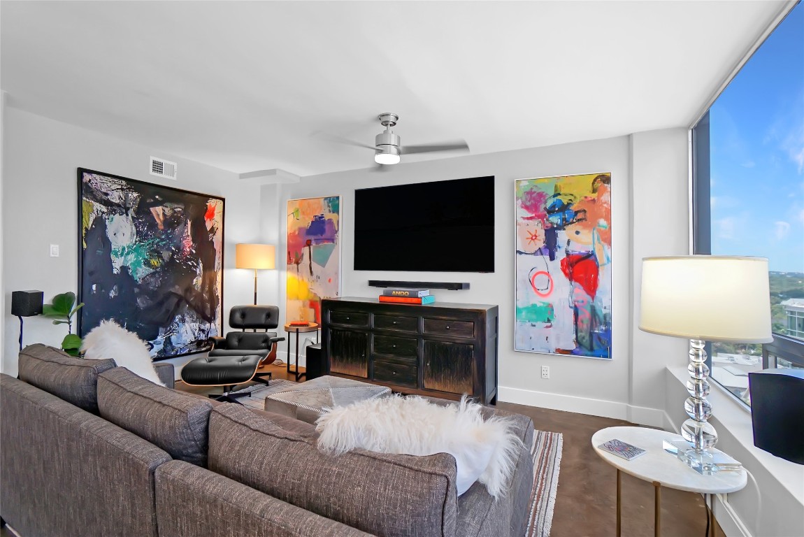 1212 Guadalupe Street, Unit 1004 Austin, TX 78701 - Photo 3 of 33 Living room featuring baseboards and a ceiling fan