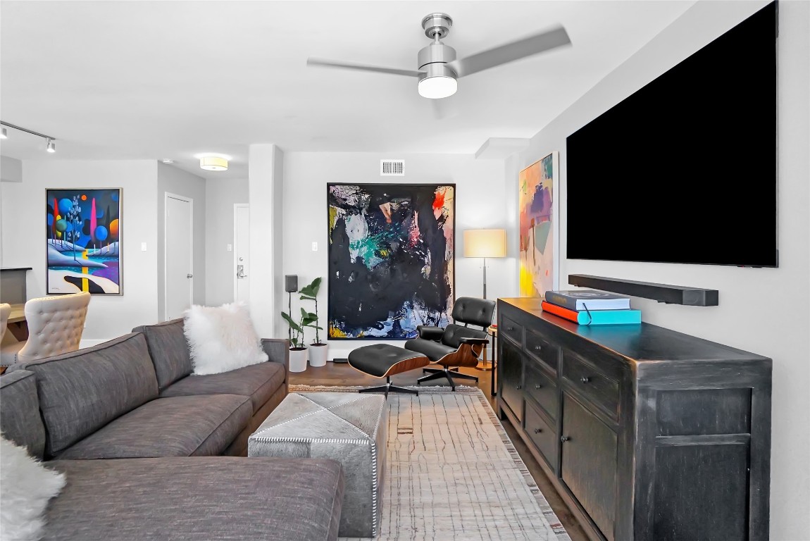 1212 Guadalupe Street, Unit 1004 Austin, TX 78701 - Photo 4 of 33 Living area featuring a ceiling fan, wood finished floors, and track lighting