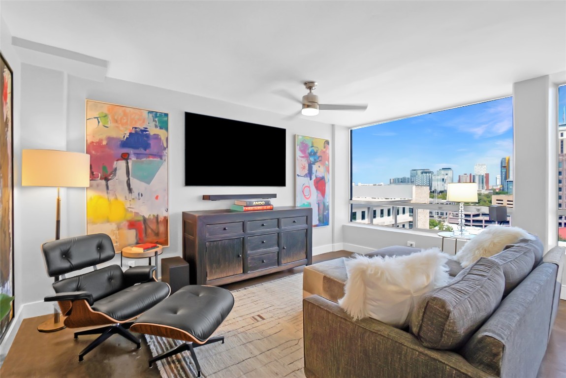 1212 Guadalupe Street, Unit 1004 Austin, TX 78701 - Photo 6 of 33 Living room featuring a ceiling fan and light wood finished floors