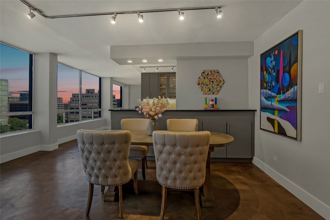 1212 Guadalupe Street, Unit 1004 Austin, TX 78701 - Photo 10 of 33 Dining area featuring finished concrete floors, a view of city, and rail lighting