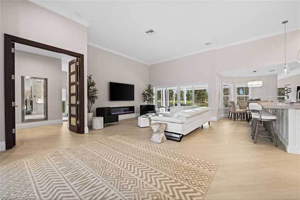 2022 Duke Drive Naples, FL 34110 - Photo 12 of 40 a living room with furniture and a flat screen tv